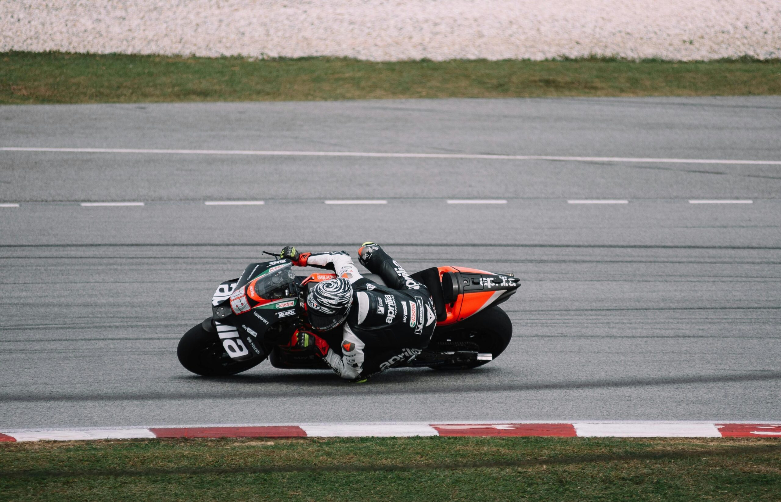 MotoGP rider navigating a tight corner during a race