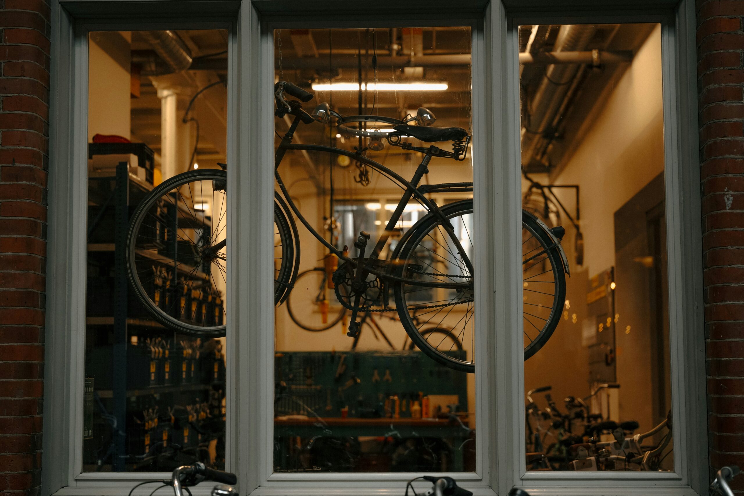 A MotoGP bike suspended inside a wind tunnel setup with engineers analyzing data.
