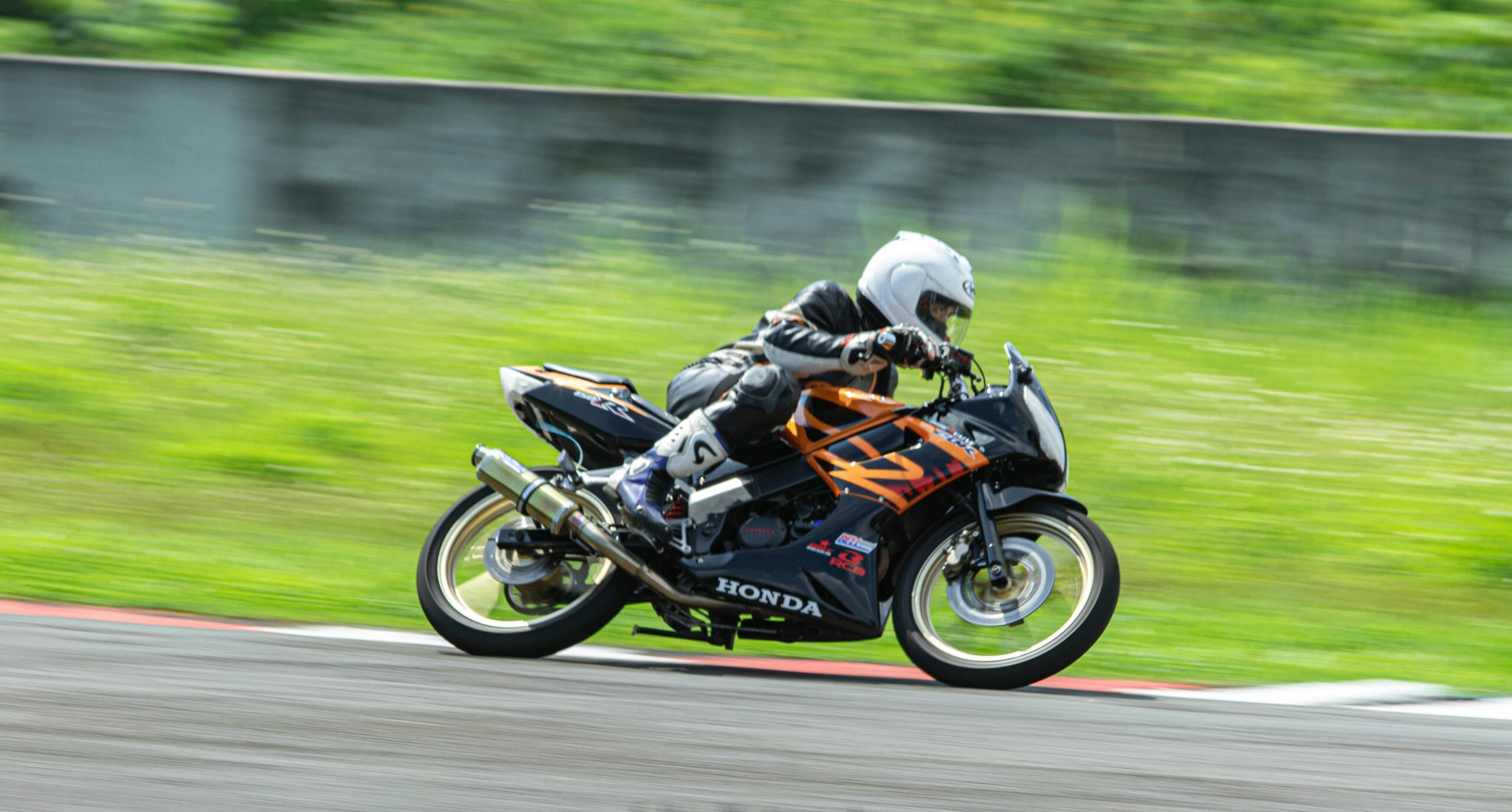 A MotoGP bike mid-turn showcasing its aerodynamic design