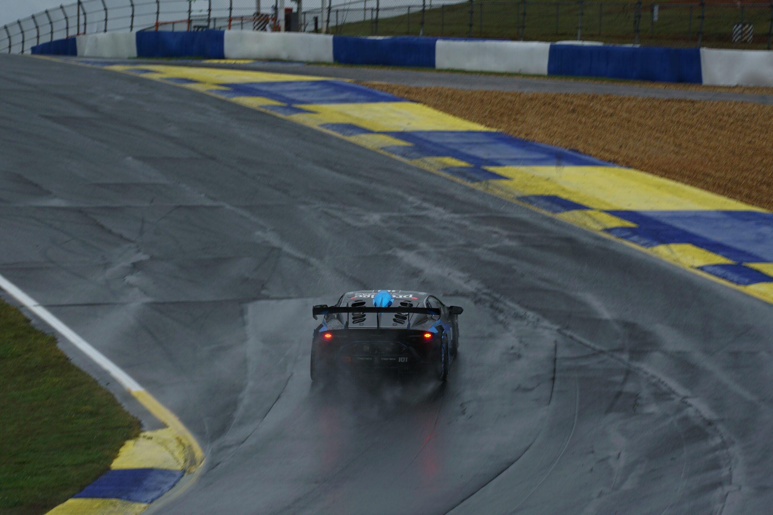 MotoGP rider navigating a wet track during heavy rain