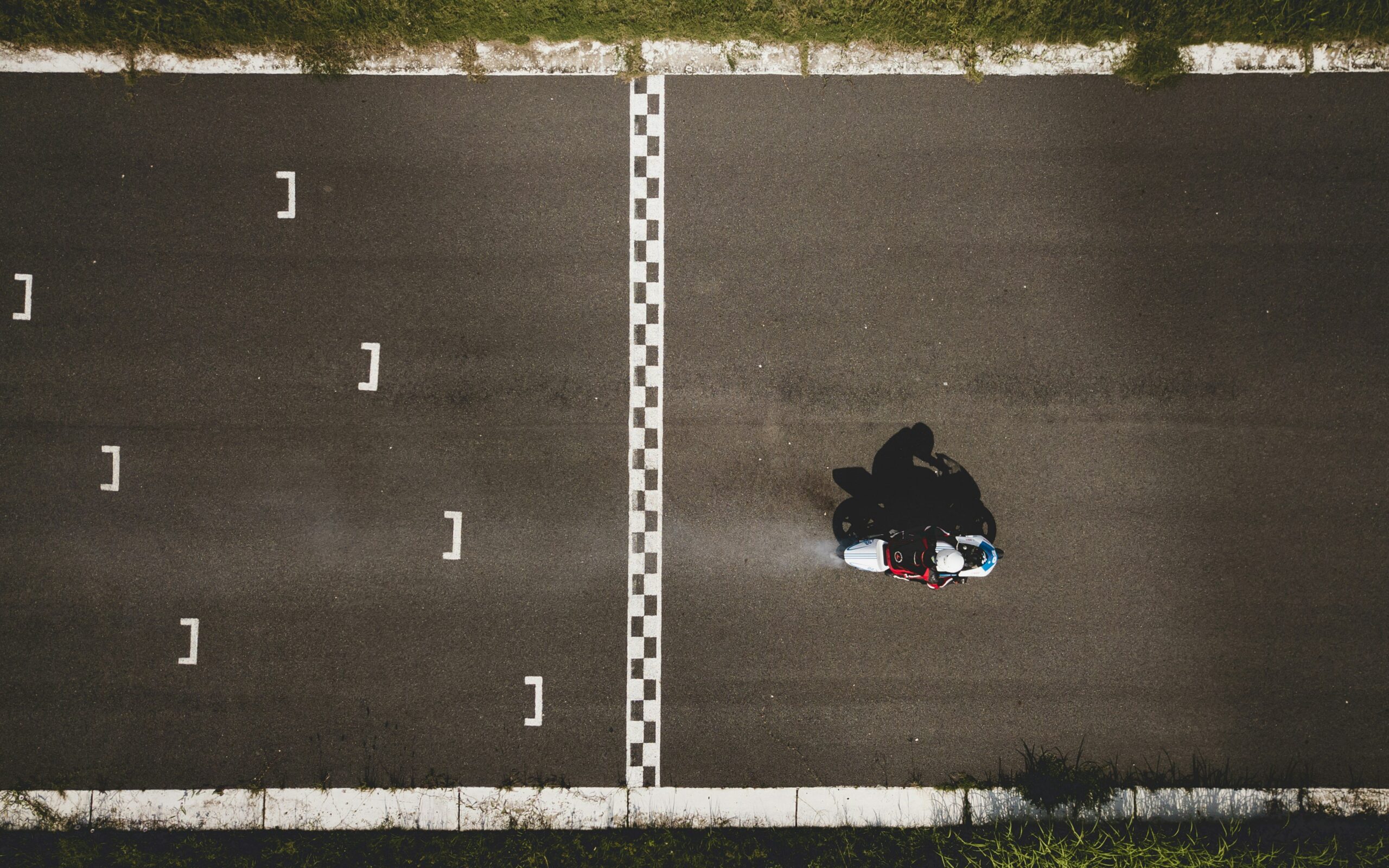 Photo of riders navigating through complex corners with arrows highlighting braking points