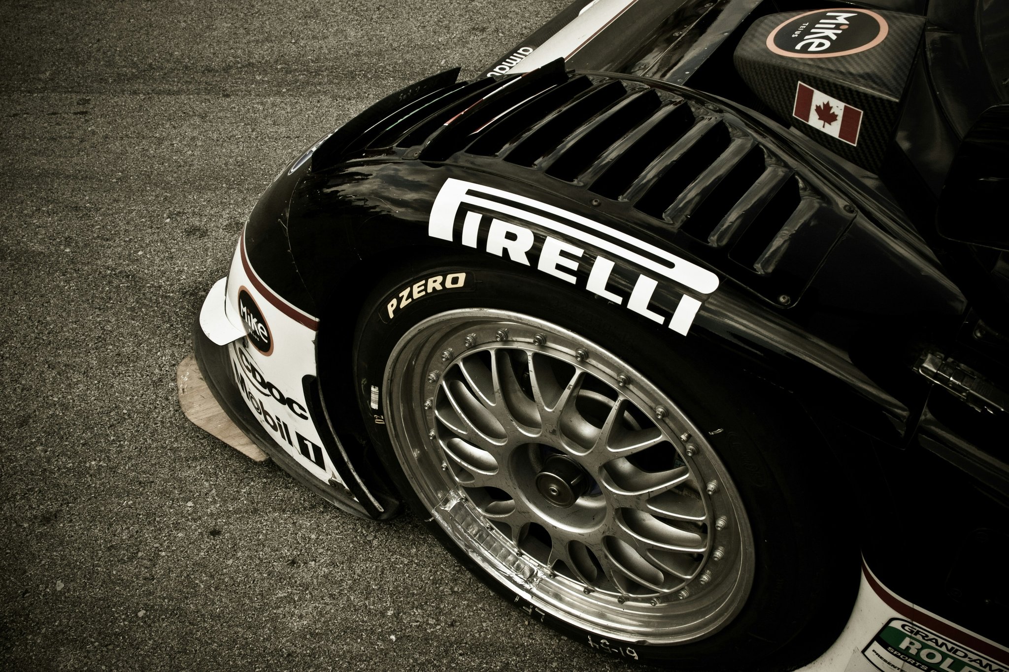 Close-up shot of a MotoGP bike tire showing intricate tread patterns and branding