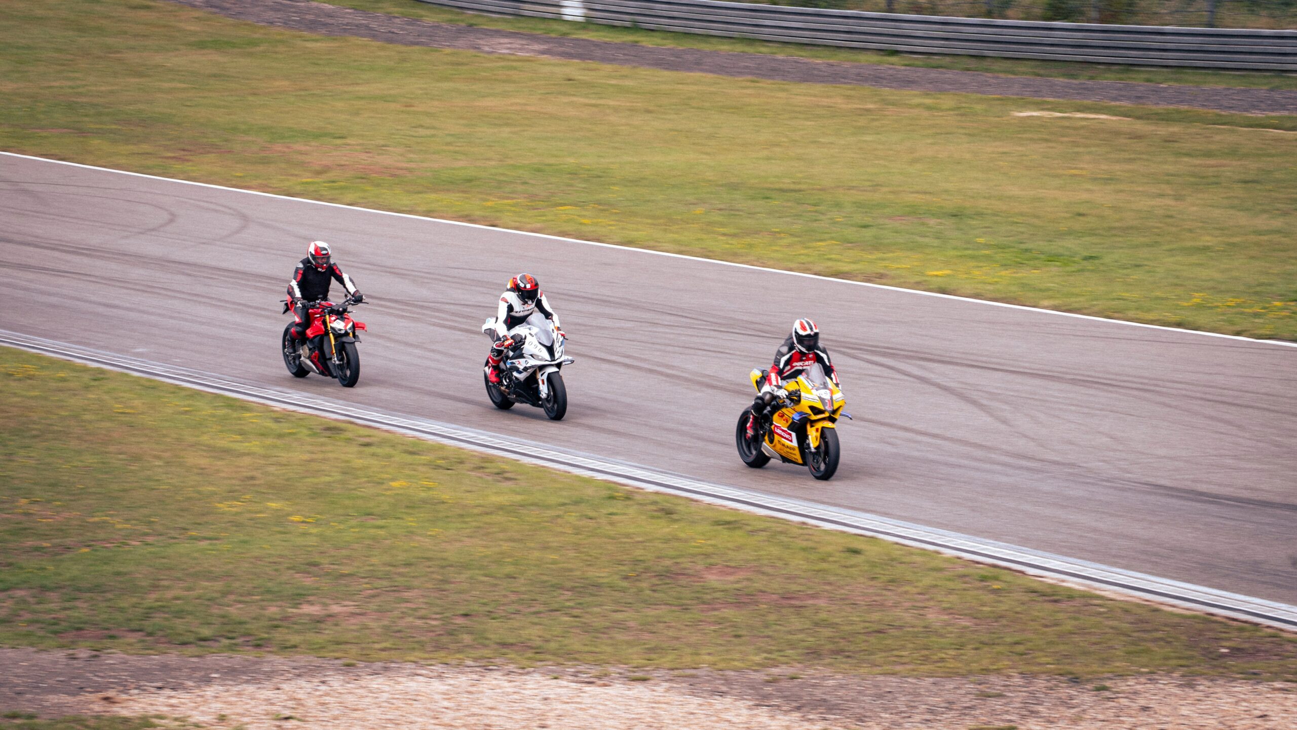 Close-up shot of red-and-white TecPro barriers lining a MotoGP track