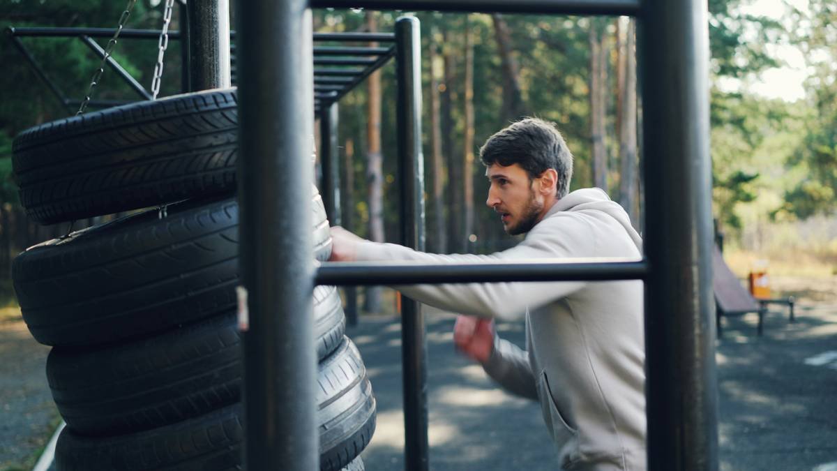 Marc Márquez performing weightlifting exercises in a gym.