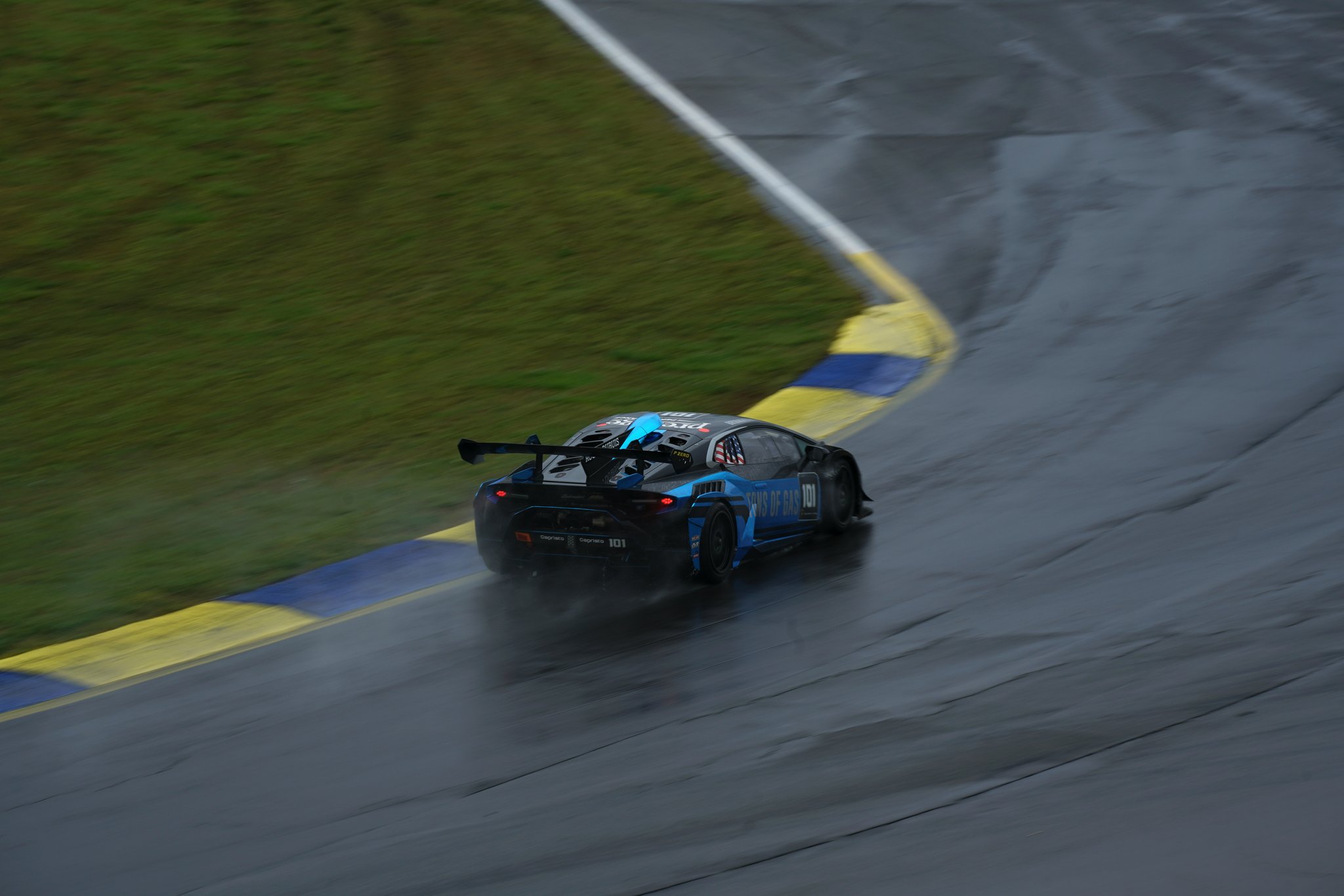 Photo of Valentino Rossi celebrating victory after a wet MotoGP race