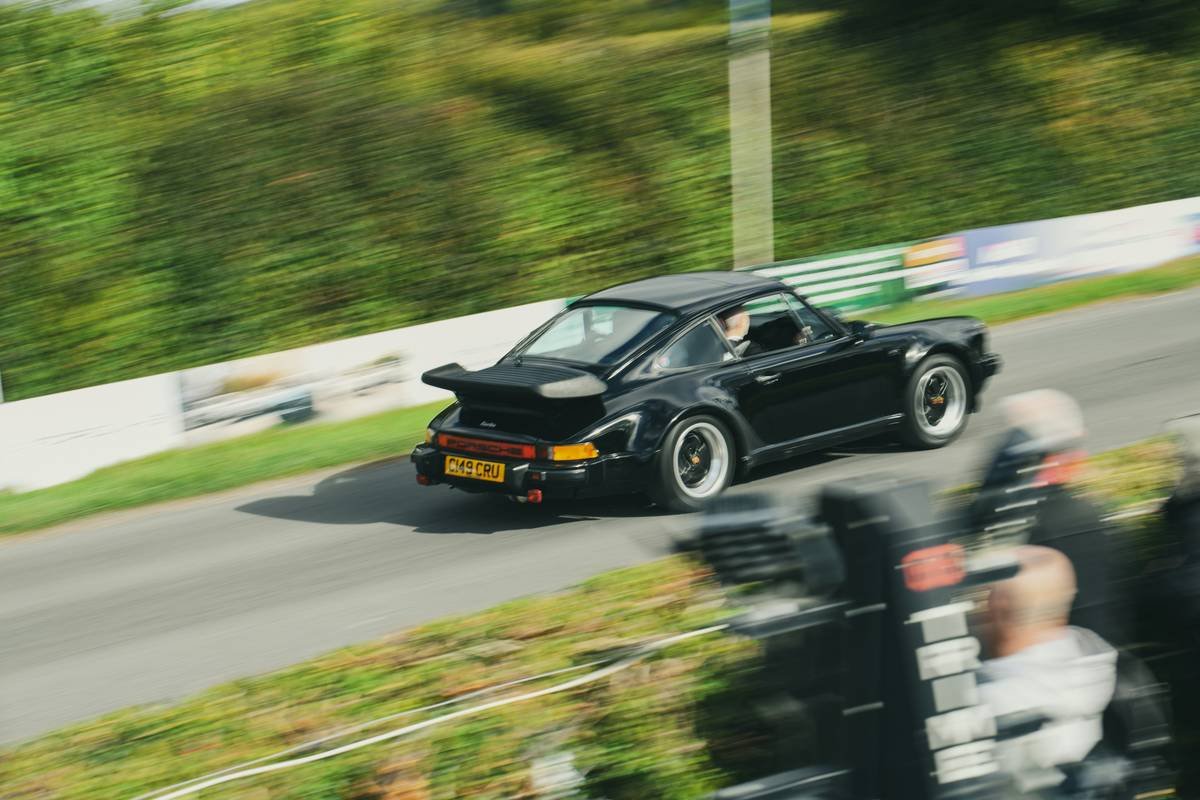 Close-up of a MotoGP bike equipped with sensors and cameras during a race.