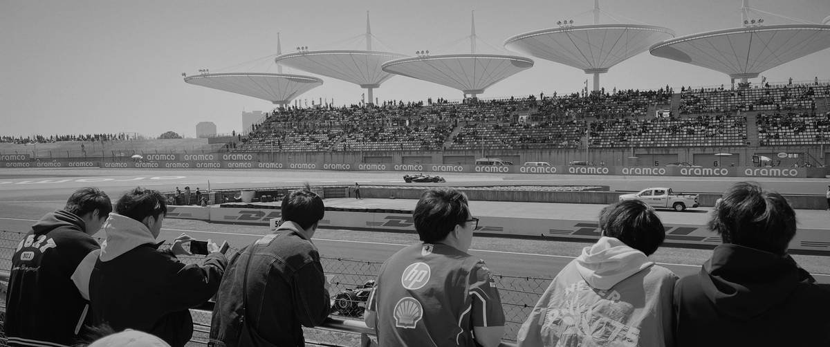 Fans holding helmets as they wait for rider autographs