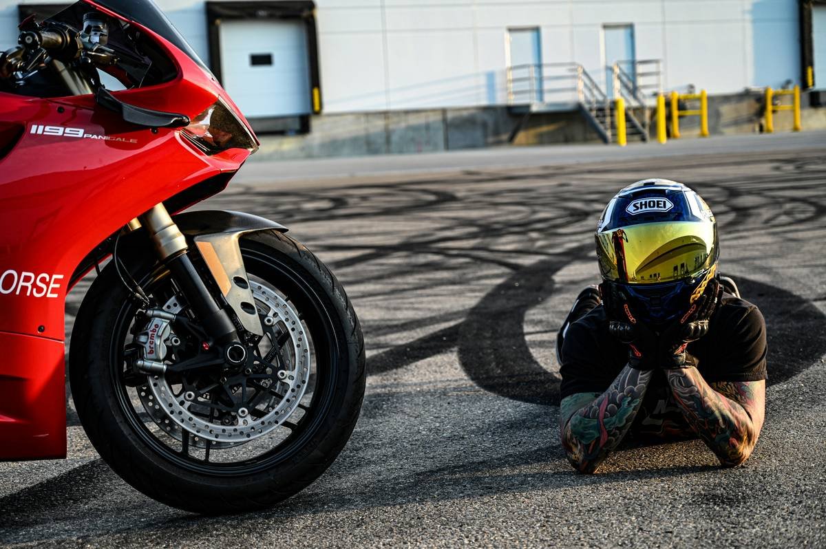 MotoGP rider adjusting advanced helmet technology