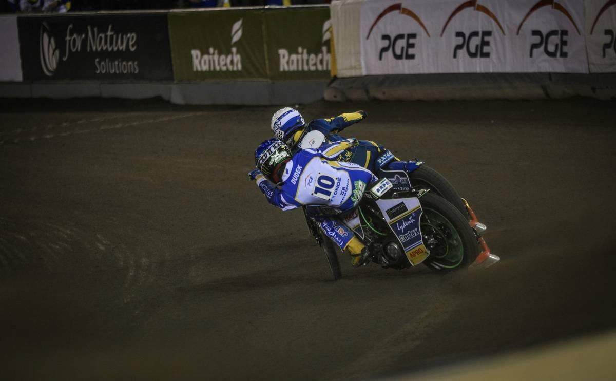 A MotoGP rider skidding off the track during a turn