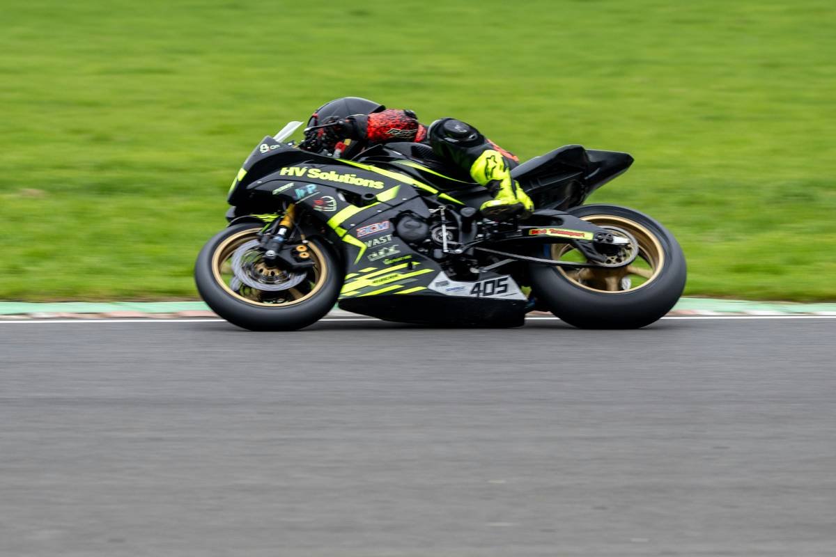 A MotoGP rider taking a sharp corner with perfect lean angle