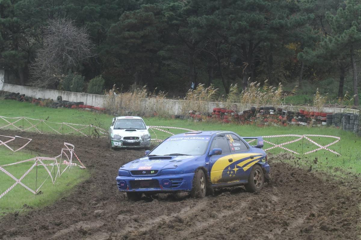 MotoGP rider leaning into a challenging corner with visible lean angle and sparks flying